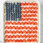 4th of July cake positioned in a white pan on a white marble surface.