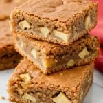 A stack of apple blondies on a marble surface.