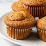 Applesauce muffins on a white plate.