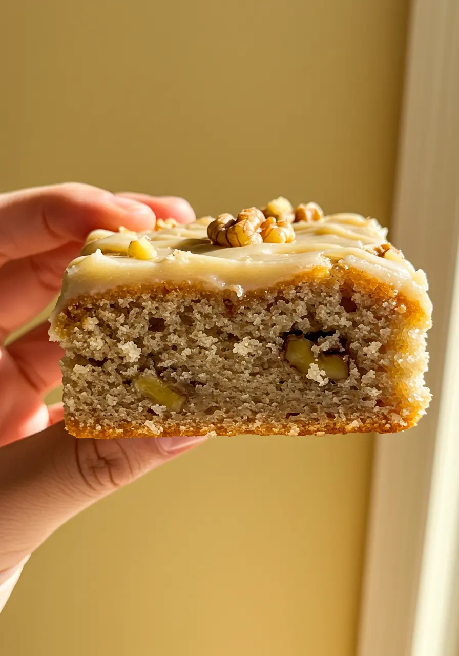 A hand holding a Banana bread brownie.