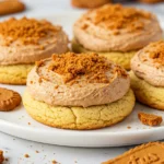 Biscoff cookies placed on a white plate with scattered whole Lotus Biscoff biscuits and crumbs.