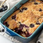 Blueberry Dump Cake on a blue baking dish.