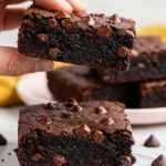 A hand holding a chickpea brownie.