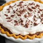 Chocolate cream pie in a white dish.