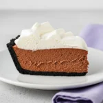 A slice of chocolate mousse pie on a white plate.