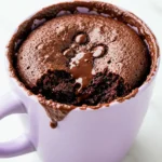 Chocolate Mug Cake on a light purple microwave-safe mug.