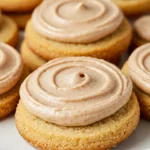 Churro cookies placed on a white plate against a light purple surface.