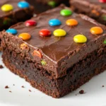 Cosmic brownies on a white plate against a light blue surface.