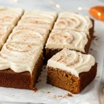 Gingerbread cake cut into slices and placed over a piece of parchment paper.