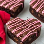 Heart shaped brownies and a red napkin beside them.