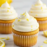 Lemon cupcakes on a white marble plate.
