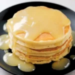 Lemon compote drizzled over pancakes.