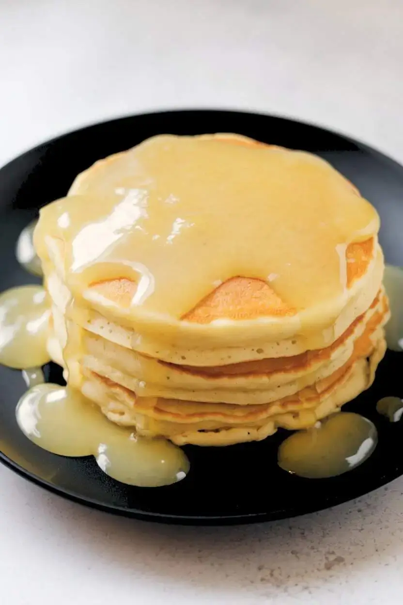 Lemon compote drizzled over pancakes.