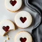 Linzer cookies and a light gray surface.