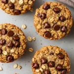 Oatmeal chocolate chip muffins on a gray surface.