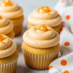 Orange cupcakes on a light gray surface.