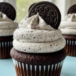 Oreo cupcakes placed on a light blue surface.