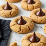 Peanut butter blossoms on a white marble surface.