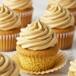 Peanut butter cupcakes placed on a white marble surface.