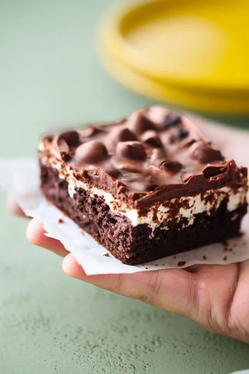 Piece of heavenly hash brownies held by a hand.