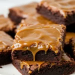 Salted caramel brownies on a white plate.