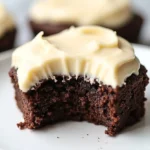 brownie with cream cheese frosting has a bite taken out of it.