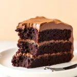 A slice of chocolate coffee cake with a bite taken out of it.