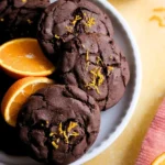 orange chocolate cookie serbian on a white plate with some oranges around.