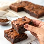 A hand holding a Sourdough Discard Brownie.